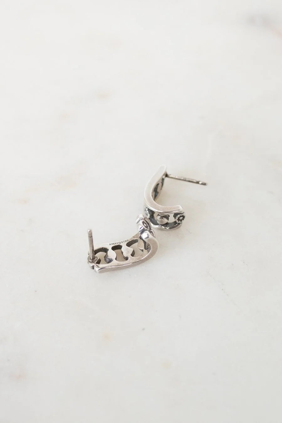 Silver earring on a white background