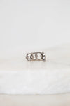 Silver ring with a unique design on a white background