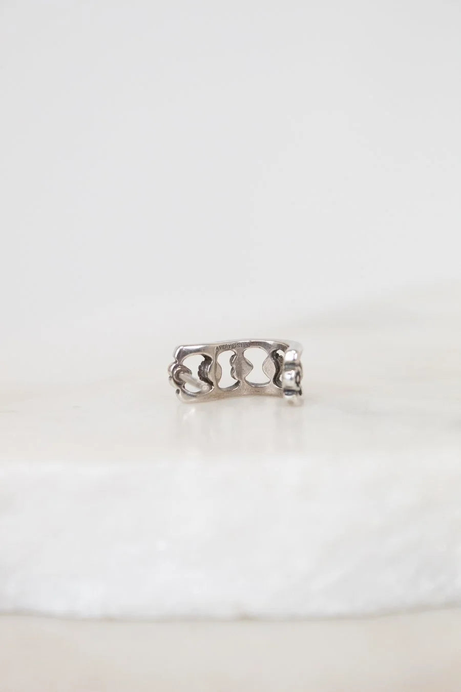 Silver ring with a unique design on a white background