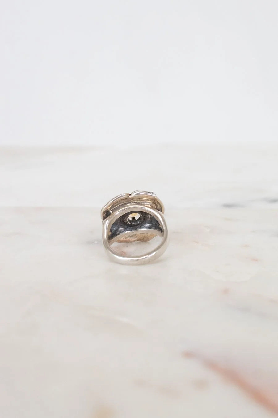 Silver ring on a marble surface