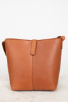 Brown leather handbag on a light gray background