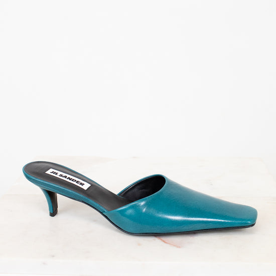 Teal high-heeled shoe on a white background