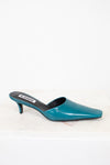 Teal high-heeled shoe on a white background