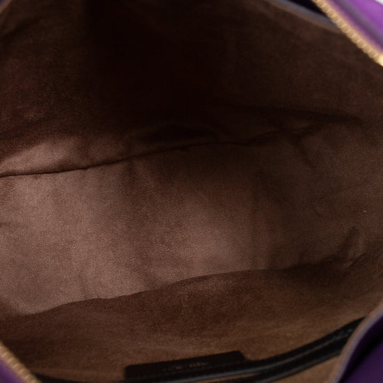 Close-up of a brown leather bag interior with a visible brand label 
