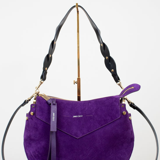 Purple handbag with gold accents on a white background