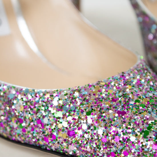 Close-up of a glittery shoe with colorful rhinestones on a white background
