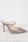Sparkly high-heeled shoe with multicolor embellishments on a light background.