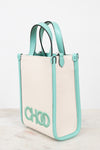 A structured tote bag with a cream canvas body and mint green leather trim, handles, and side borders. The bag features a large mint green 'CHOO' logo on the front, set against a clean white background.