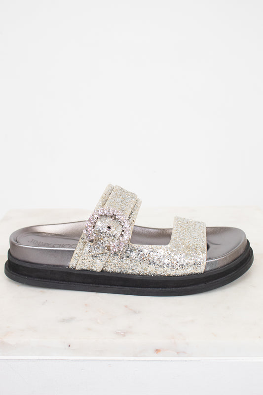 Silver sandal with rhinestone embellishments on a white background