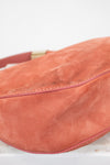 Close-up of a pink suede bag on a white background