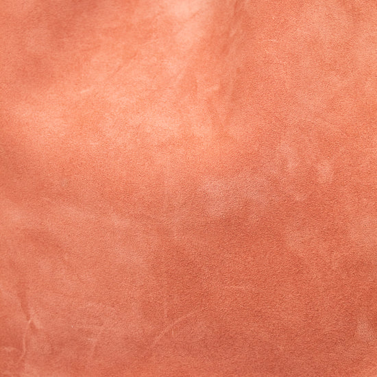 Close-up of a pinkish-brown leather handbag with 'Jimmy Choo' branding.