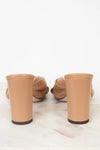 Tan high-heeled shoes on a white background