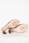 Pair of beige shoes on a white background