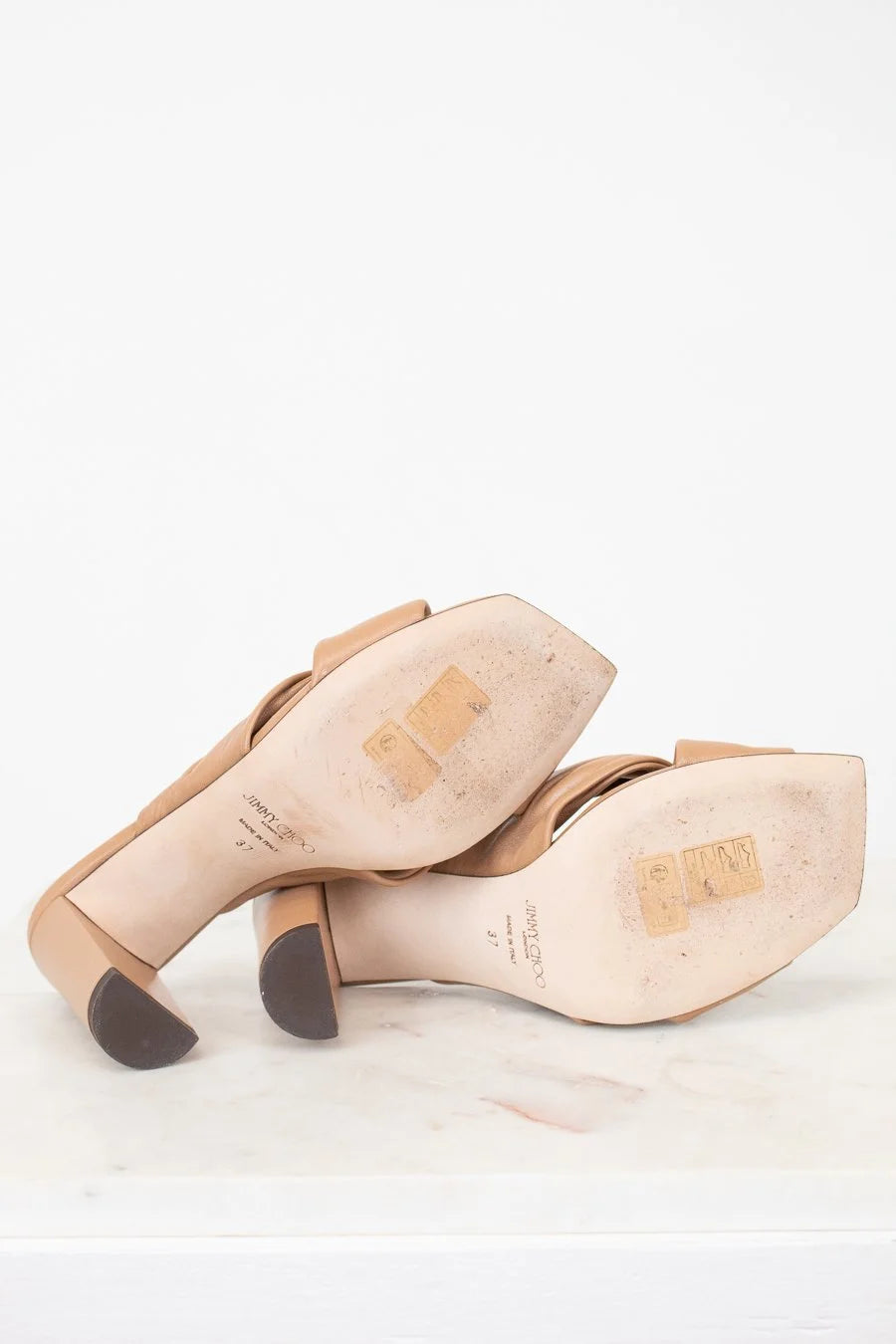 Pair of beige shoes on a white background