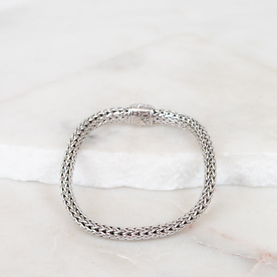 Silver bracelet on a marble surface