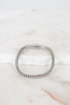 Silver bracelet on a marble surface