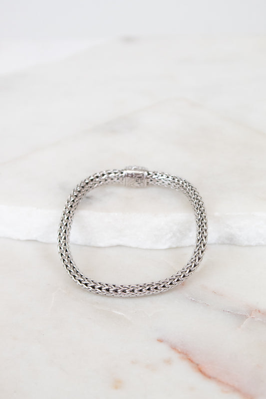 Silver bracelet on a marble surface