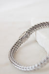 Silver braided bracelet on a white background