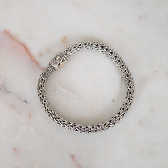 Silver chain bracelet on a marble surface