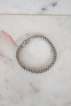 Silver chain bracelet on a marble surface