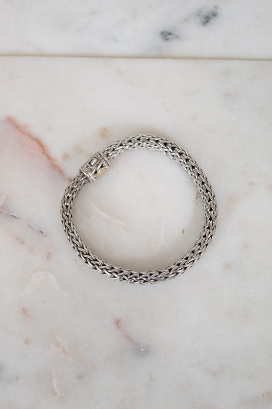 Silver chain bracelet on a marble surface