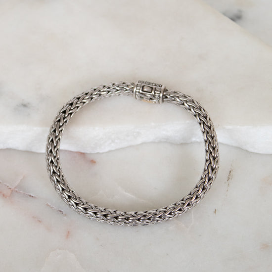Silver chain bracelet on a marble surface