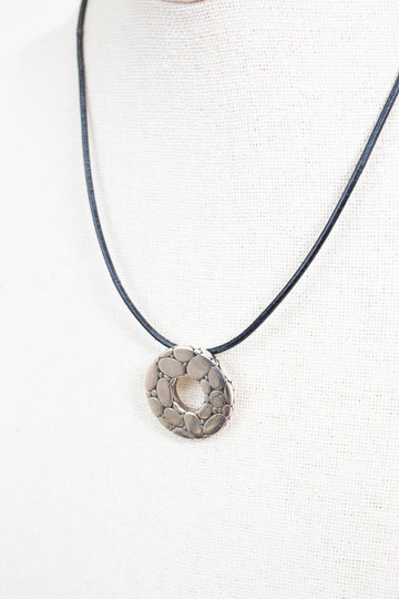 Necklace with a circular pendant on a white background