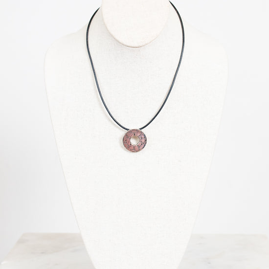Necklace with a silver pendant on a white background