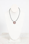Necklace with a silver pendant on a white background