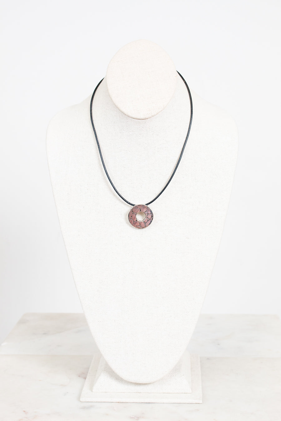 Necklace with a silver pendant on a white background