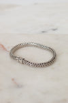 Silver bracelet on a marble surface