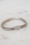 Silver bracelet on a marble surface