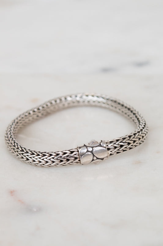 Silver bracelet on a marble surface