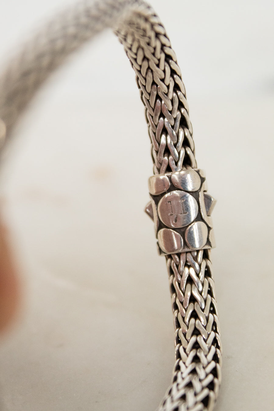 Close-up of a silver bracelet with a blurred background
