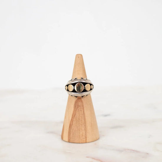 Ring on a wooden cone with a white background