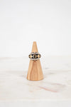 Ring on a wooden cone with a white background