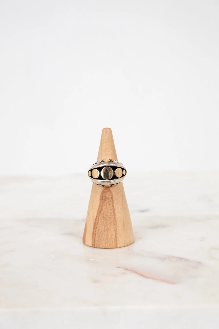 Ring on a wooden cone with a white background