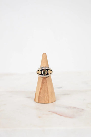 Ring on a wooden cone with a white background