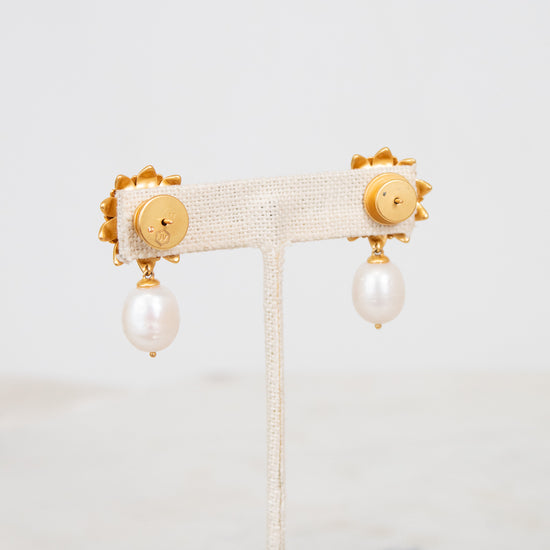 Pair of earrings with pearl drops on a white background