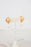 Pair of earrings with pearl drops on a white background