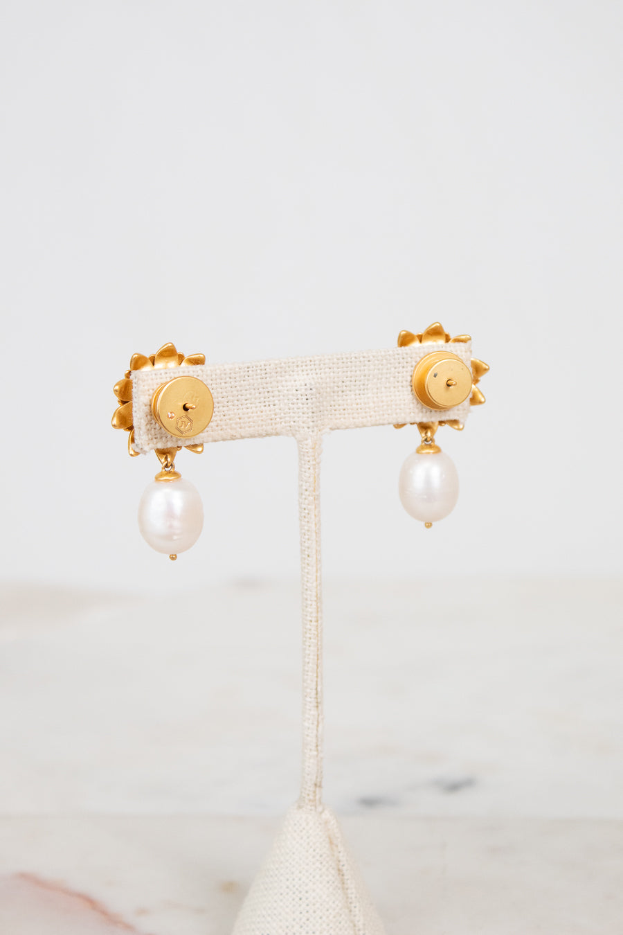 Pair of earrings with pearl drops on a white background