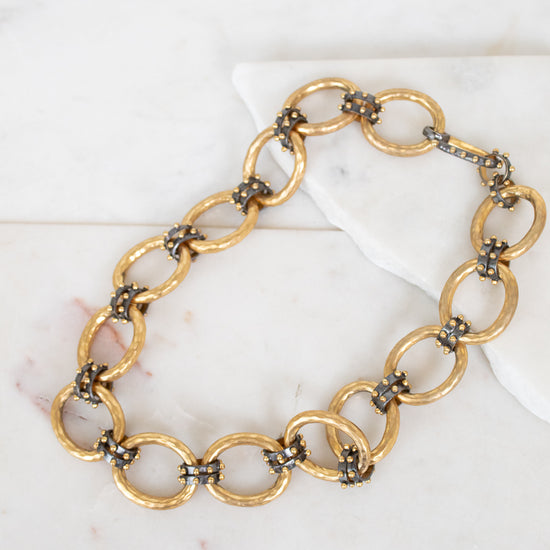 Gold chain necklace on a marble surface