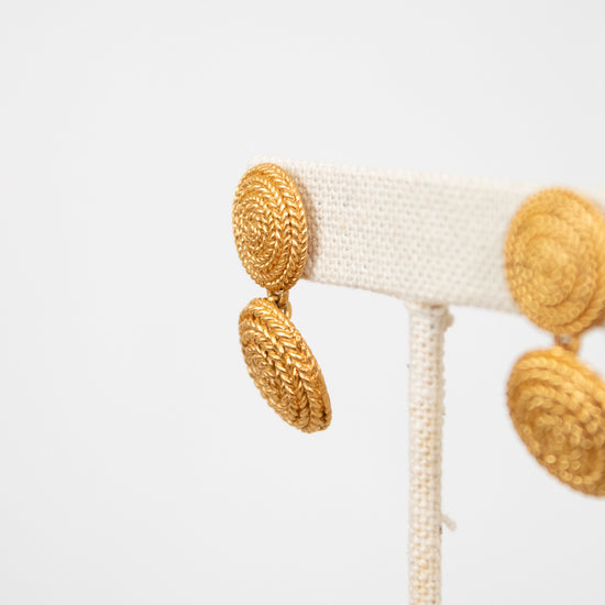 Close-up of a decorative item with gold circular elements on a white background