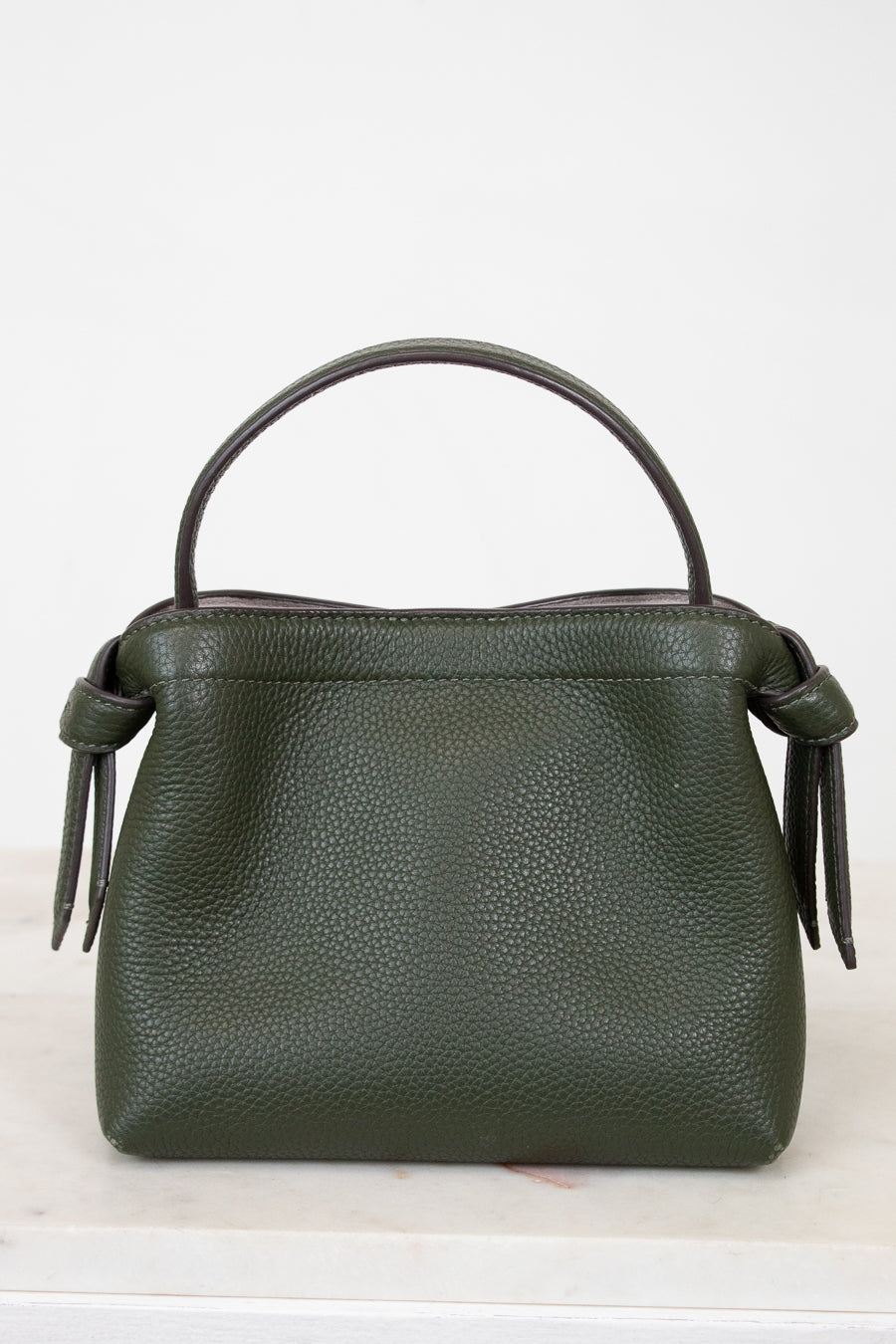 Green handbag with a handle on a white background