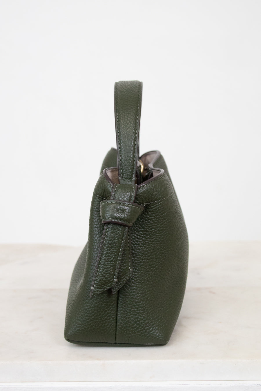 Green leather handbag on a white background