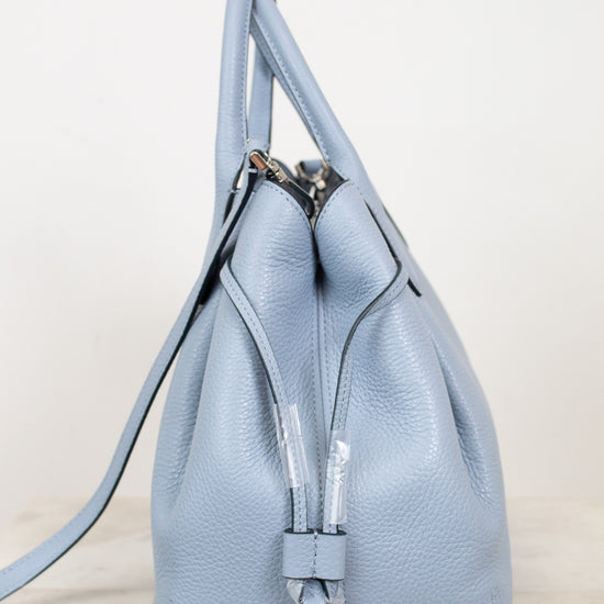 Light blue leather purse on a light gray background