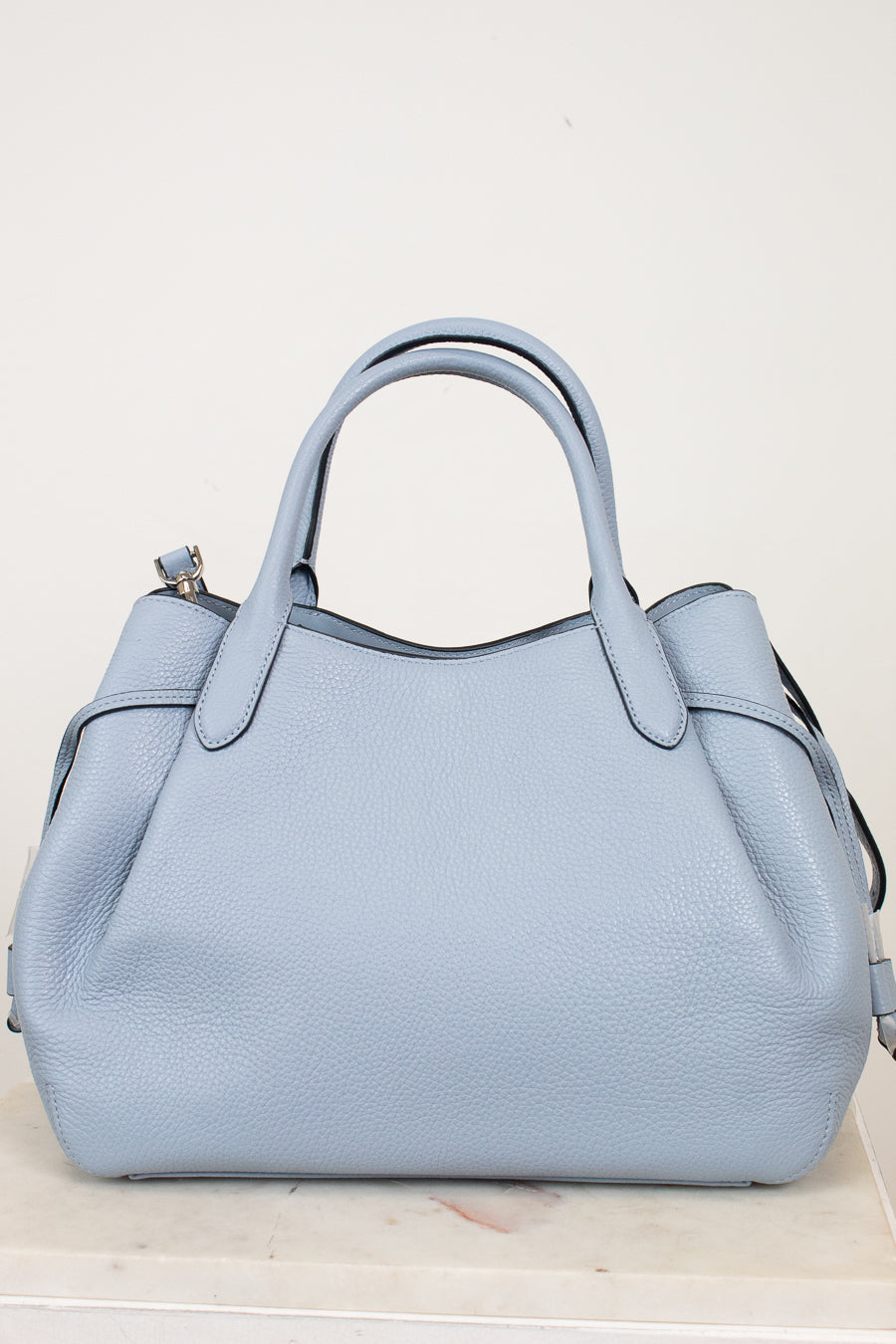Light blue handbag on a white background