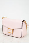 Pink handbag with gold accents on a light background