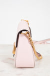 Pink handbag with gold chain on a white background