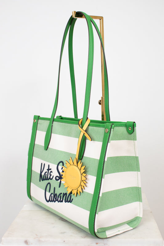 Green and white striped tote bag with a sun design and 'Kate Spade Cabana' text on a white background